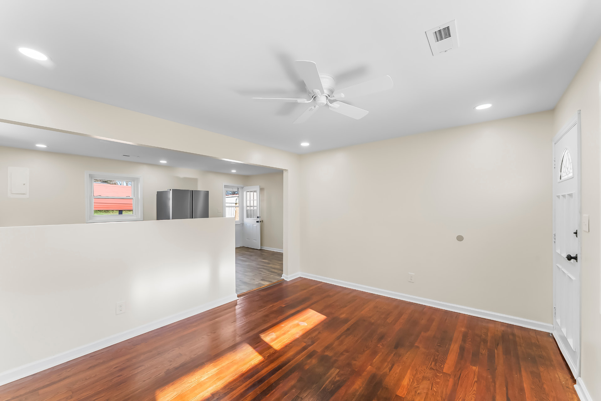 Open living area looking toward the kitchen pass-through and rear entry