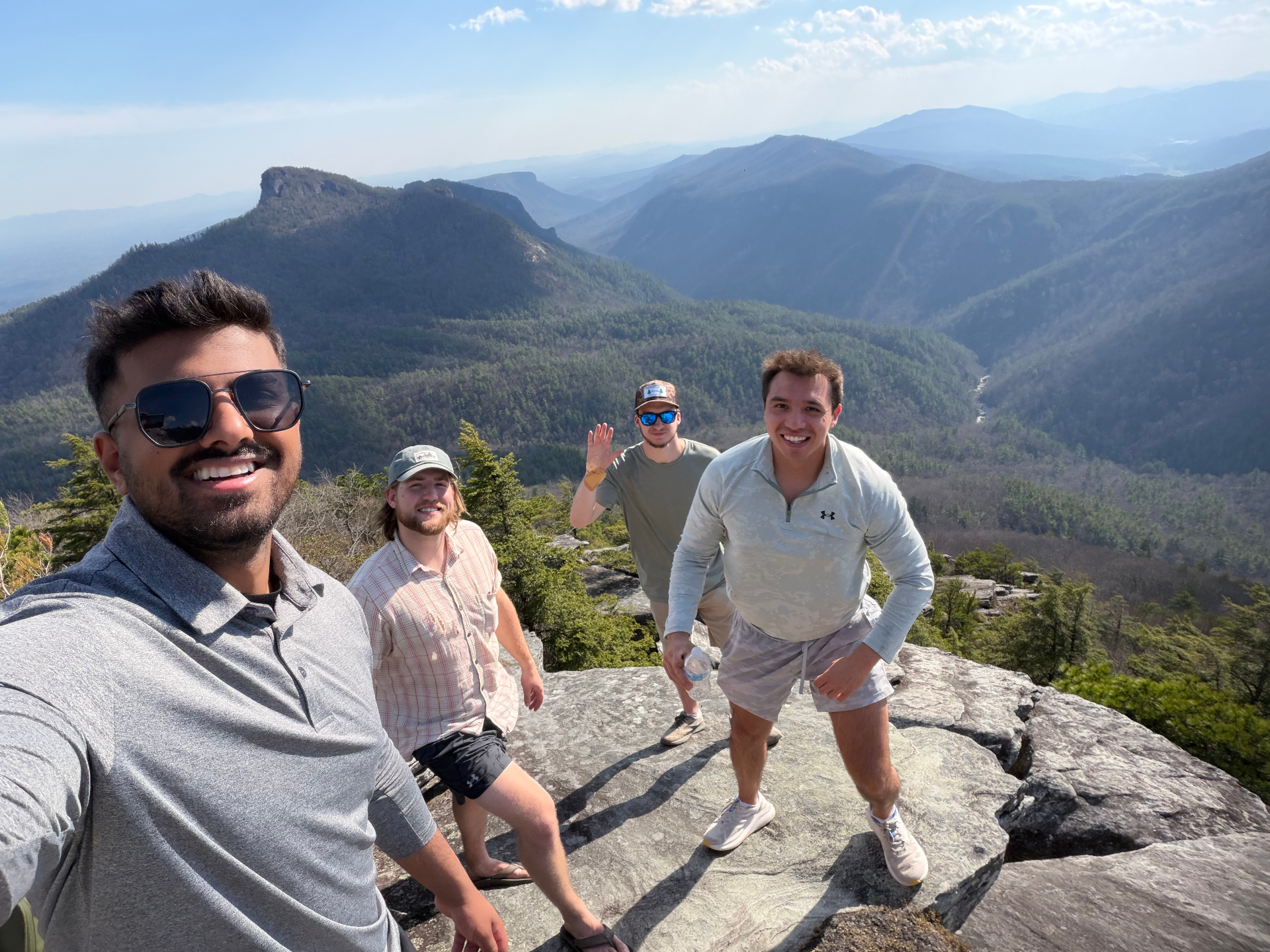 Taha with friends on a rocky overlook in the Blue Ridge mountains