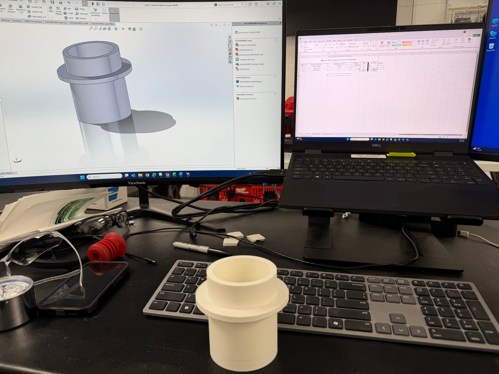 Taha's engineering workstation with CAD software and a prototype part