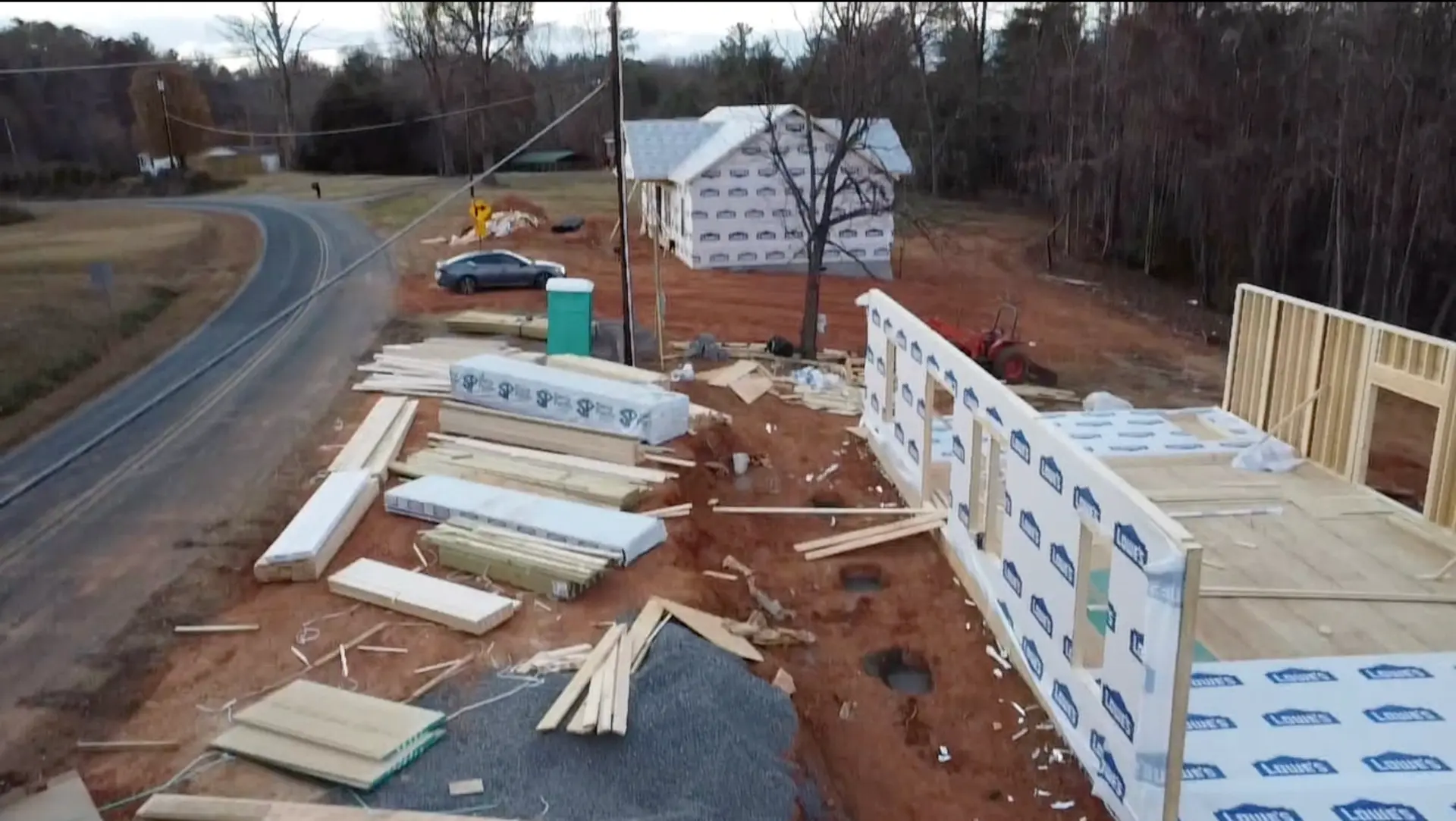Both Watson Rd homes framed and wrapped, with wall panels staged on site