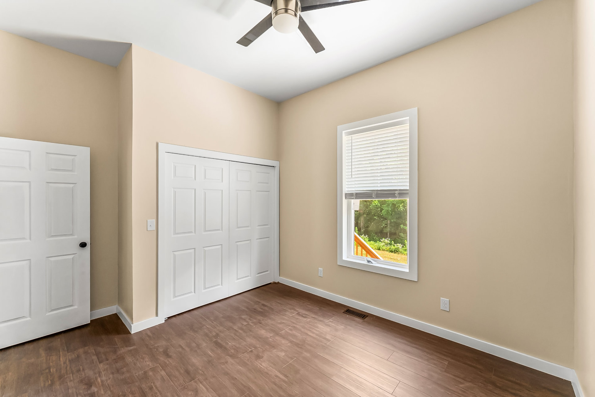 Second bedroom with new window, blinds, ceiling fan, and closet